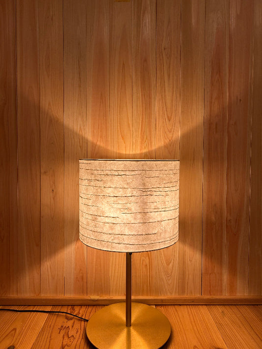 Floor lamp with washi shade on a wooden floor. soft warm glow