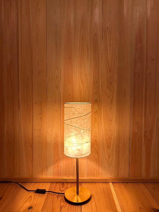 Table lamp with a textured washi shade creates warm glow