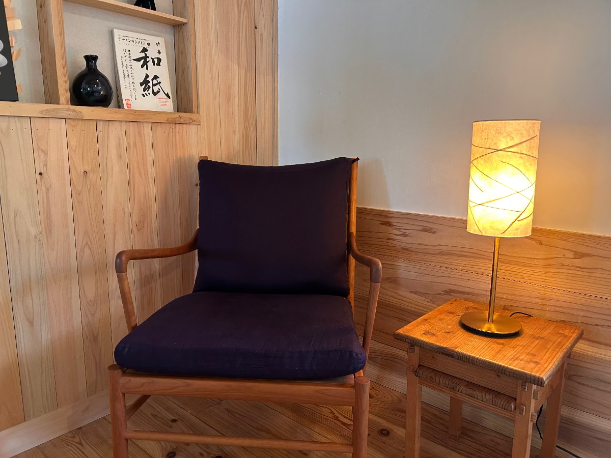 Table lamp with handmade washi lampshade next to a wooden chair