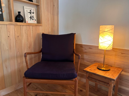 Table lamp with handmade washi lampshade next to a wooden chair