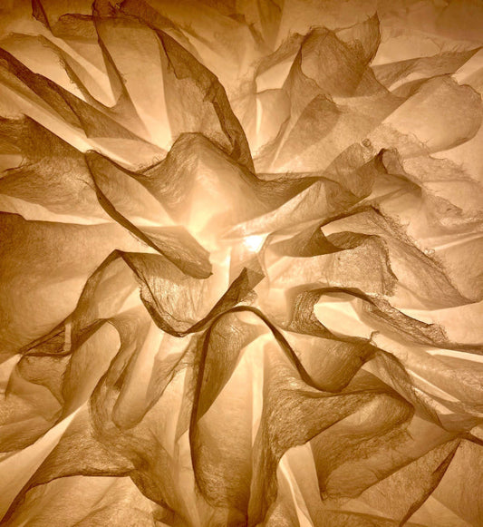 Close-up of a textured washi light with soft waves