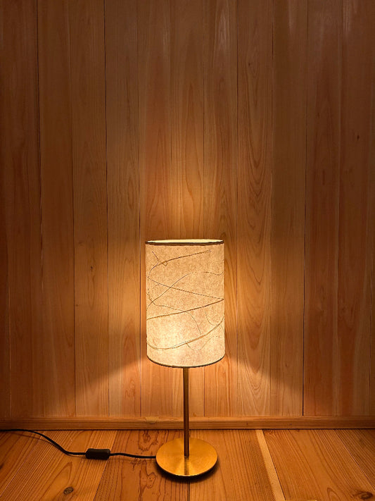 Table lamp with washi shade creates a warm and serene atmosphere.