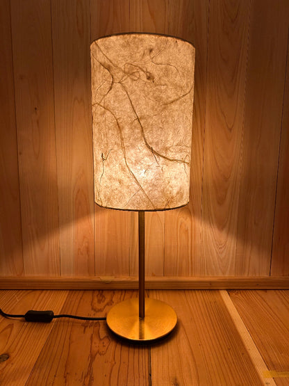 Floor lamp with marble-patterned shade on a wooden floor